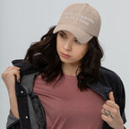 Baseball cap embroidered with the phrase ‘I Have a Cigarette in All 7 Holes’ in ornate vintage gothic lettering. Alternative fashion accessory with edgy internet humor, queer streetwear aesthetic, punk inspired style, ironic meme fashion, tattoo inspired typography, goth streetwear, adjustable dad hat, casual alternative outfit accessory, artsy statement cap, chaotic humor apparel, indie fashion, and expressive alternative clothing for concerts, festivals, everyday wear, and alternative wardrobes.