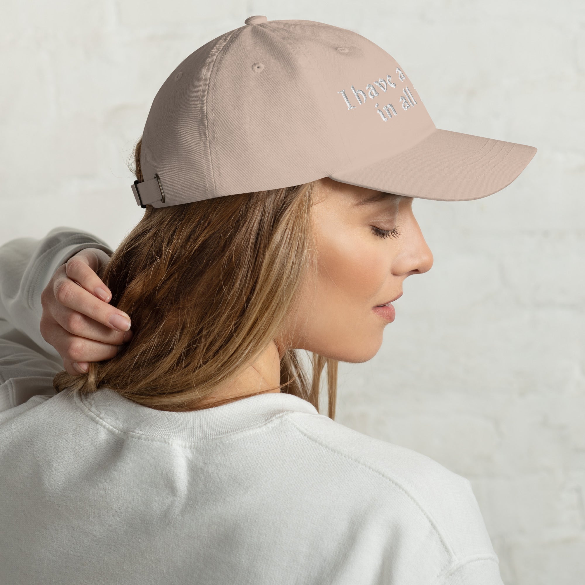 Baseball cap embroidered with the phrase ‘I Have a Cigarette in All 7 Holes’ in ornate vintage gothic lettering. Alternative fashion accessory with edgy internet humor, queer streetwear aesthetic, punk inspired style, ironic meme fashion, tattoo inspired typography, goth streetwear, adjustable dad hat, casual alternative outfit accessory, artsy statement cap, chaotic humor apparel, indie fashion, and expressive alternative clothing for concerts, festivals, everyday wear, and alternative wardrobes.
