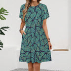 Short sleeve dress featuring the Frondescence pattern with layered tropical foliage in deep green botanical tones and an all-over nature-inspired print. Flowy casual dress with earthy jungle aesthetic, maximalist fashion, indie streetwear, botanical artwork, expressive queer friendly style, artsy everyday wear, and retro-inspired tropical clothing perfect for vacations, brunch, festivals, casual outings, and comfortable everyday alternative fashion.