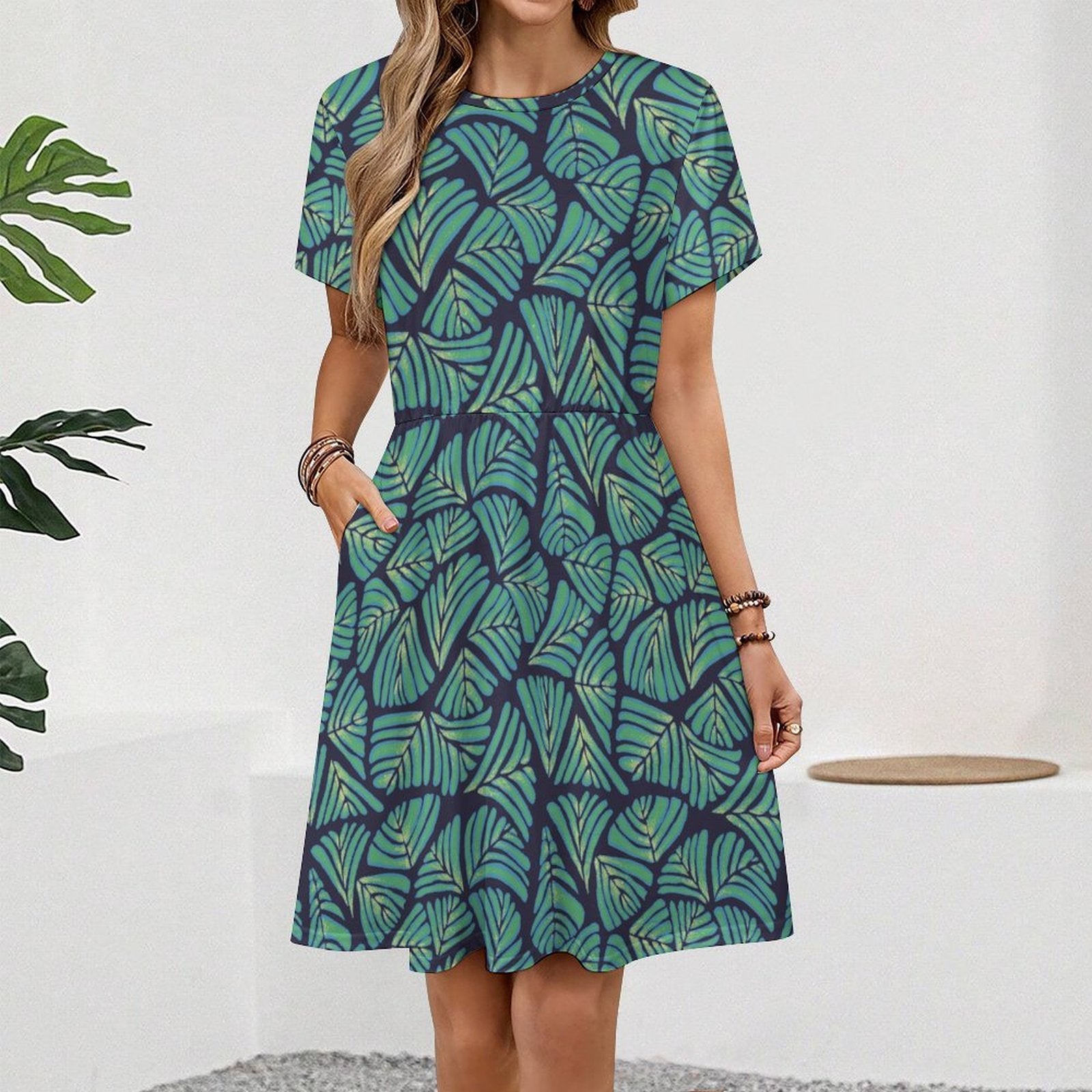 Short sleeve dress featuring the Frondescence pattern with layered tropical foliage in deep green botanical tones and an all-over nature-inspired print. Flowy casual dress with earthy jungle aesthetic, maximalist fashion, indie streetwear, botanical artwork, expressive queer friendly style, artsy everyday wear, and retro-inspired tropical clothing perfect for vacations, brunch, festivals, casual outings, and comfortable everyday alternative fashion.