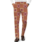 Dress pants featuring the Petal Circuit in Mulled Spice pattern with warm rust, plum, cream, and golden geometric floral shapes in a retro-inspired all-over print. Statement trousers with vintage autumn aesthetic, maximalist fashion, indie streetwear, mod inspired design, expressive queer friendly style, artsy alternative clothing, colorful geometric pattern, and bold patterned pants perfect for concerts, festivals, creative workwear, nightlife, parties, and everyday alternative fashion.