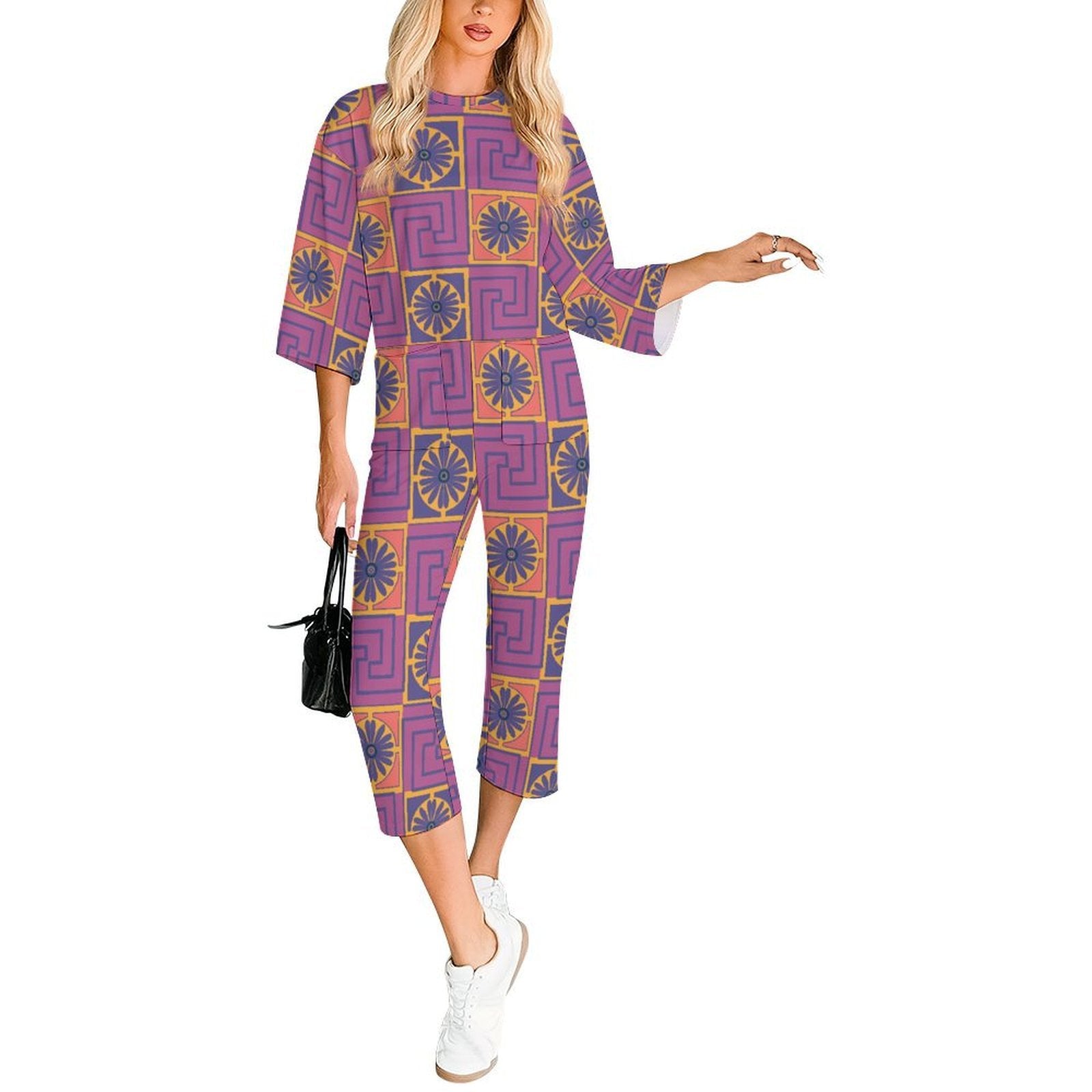 3/4 sleeve jumpsuit featuring the Petal Circuit in Disco Fig pattern with bold purple, pink, orange, and cream geometric floral shapes in a retro-inspired all-over print. Relaxed statement outfit with maximalist fashion aesthetic, indie streetwear, mod inspired design, expressive queer friendly fashion, artsy casualwear, colorful geometric artwork, and playful alternative clothing perfect for festivals, vacations, brunch, concerts, creative everyday wear, and bold summer outfits.